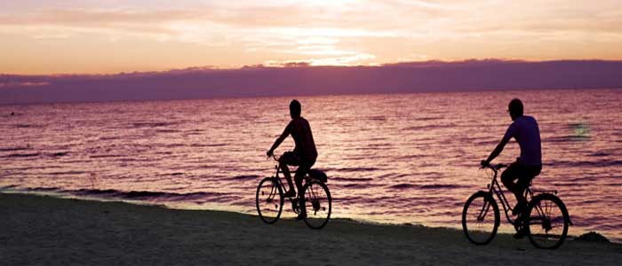 Cuba cyclists on beach