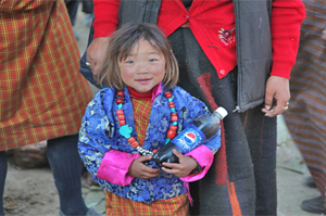Bhutan girl with pepsi Bhutan Adventure Tour
