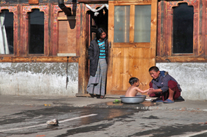 Bhutan kid bathing Bhutan girl with pepsi Bhutan Adventure Tour