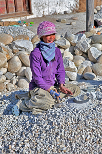 young girl breaking rocks Experience Bhutan Tour